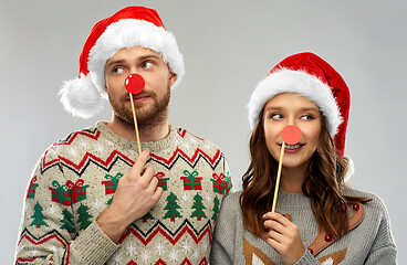 Image showing couple with christmas party props in ugly sweaters