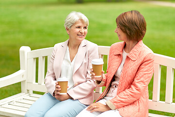 Image showing senior women or friends drinking coffee at park