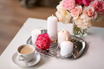 Image showing coffee, candles, garland and flowers on table