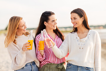 Image showing young women toasting non alcoholic drinks on beach