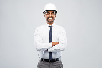 Image showing smiling indian male architect in helmet over grey