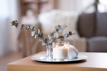 Image showing burning fragrance candle on table at cozy home