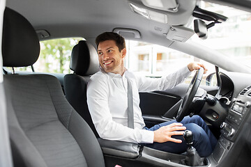 Image showing smiling man or driver driving car