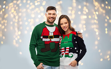 Image showing happy couple at christmas ugly sweater party