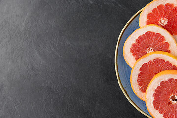 Image showing close up of fresh juicy grapefruits on plate