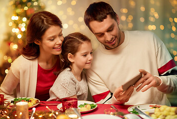 Image showing family with smartphone having christmas dinner