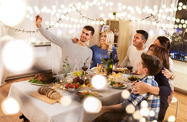 Image showing family having dinner party and taking selfie