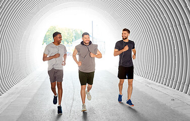 Image showing male friends with earphones running outdoors