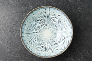 Image showing close up of blue ceramic plate on slate background