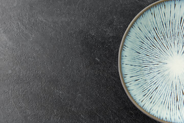 Image showing close up of blue ceramic plate on slate background