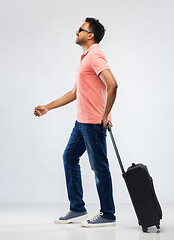 Image showing smiling indian man in polo shirt with travel bag