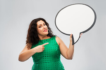 Image showing happy woman in green dress holding speech bubble