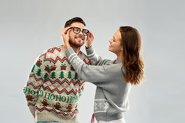 Image showing happy couple at christmas ugly sweater party