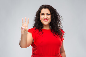 Image showing happy woman in red dress showing three fingers