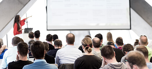 Image showing Female speeker having talk at public event.