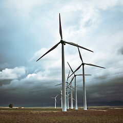 Image showing Wind turbines generating electricity in a stormy weather