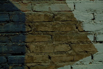 Image showing Brick wall with painted pattern on exposed bricks