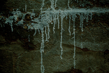 Image showing Messy drizzles of white paint on an old wall