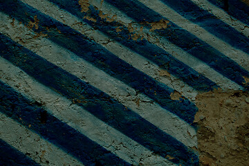 Image showing Diagonal blue and white stripes on an old wall