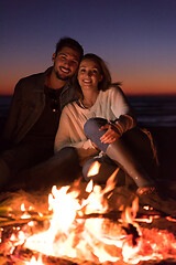 Image showing portrait of young Couple enjoying  at night on the beach