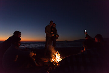 Image showing Friends having fun at beach on autumn day