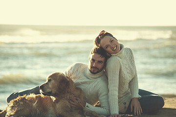 Image showing Couple with dog enjoying time on beach