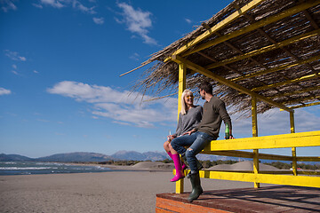 Image showing young couple drinking beer together at the beach