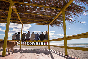 Image showing Group of friends having fun on autumn day at beach