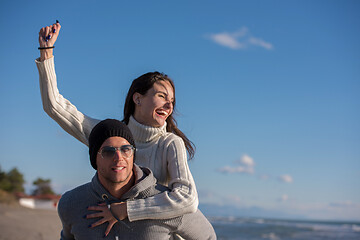 Image showing couple having fun at beach during autumn