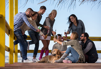 Image showing Group of friends having fun on autumn day at beach