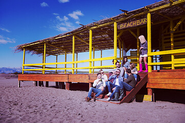 Image showing Group of friends having fun on autumn day at beach