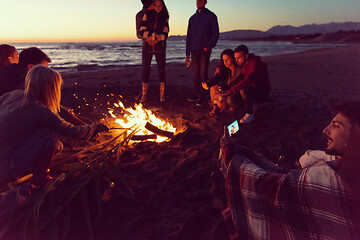 Image showing Friends having fun at beach on autumn day