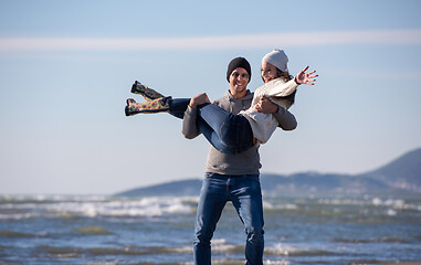 Image showing Loving young couple on a beach at autumn sunny day