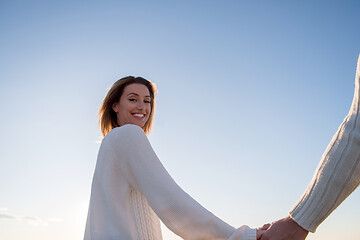 Image showing Loving young couple on a beach at autumn sunny day