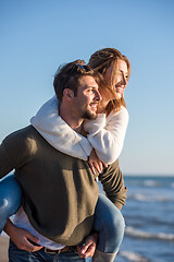 Image showing couple having fun at beach during autumn