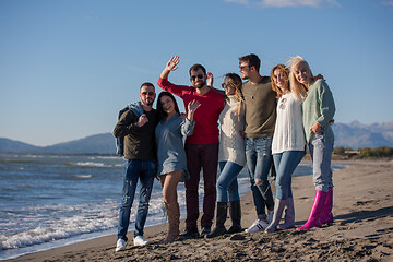 Image showing portrait of friends having fun on beach during autumn day