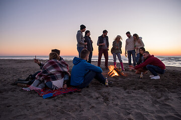 Image showing Friends having fun at beach on autumn day