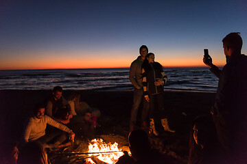 Image showing Friends having fun at beach on autumn day