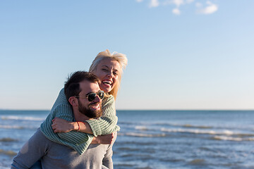 Image showing couple having fun at beach during autumn