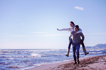 Image showing couple having fun at beach during autumn