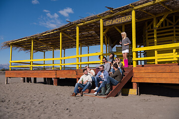 Image showing Group of friends having fun on autumn day at beach