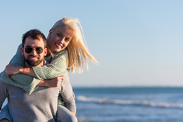 Image showing couple having fun at beach during autumn