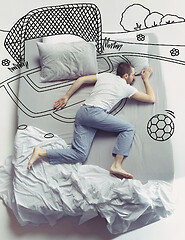Image showing Top view photo of young man sleeping in a big white bed and his dreams