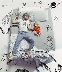 Image showing Top view photo of young man sleeping in a big white bed and his dreams