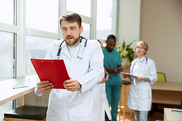 Image showing Beautiful surprised doctor over hospital background