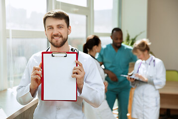 Image showing Beautiful smiling doctor over hospital background