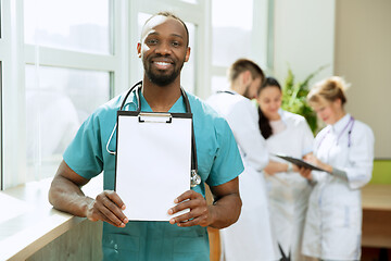 Image showing Beautiful smiling african doctor over hospital background