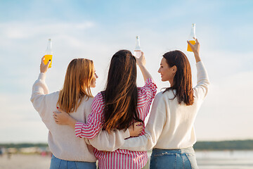 Image showing young women toasting non alcoholic drinks on beach