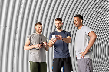 Image showing sporty men or friends with smartphone outdoors