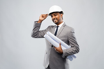 Image showing indian male architect in helmet with blueprints